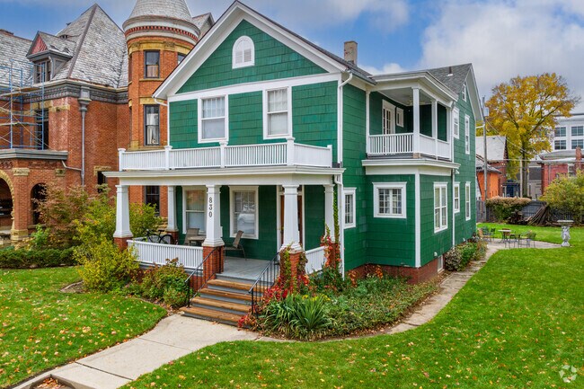This lovely green two-story home in Fort Wayne's West Central features a second story balcony.