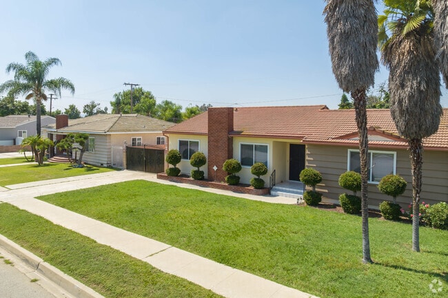 Vincent neighborhood homes have palm trees and luscious, green lawns.