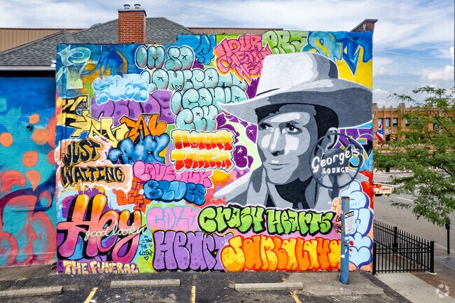 Beautiful murals on buildings make a downtown drive in Whittier Park brighter.