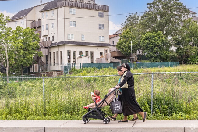 Modest dress codes are mandatory in Kiryas Joel, where women dress in long skirts, long sleeves, and often cover their hair, while men wear traditional black suits, hats, and sidelocks.