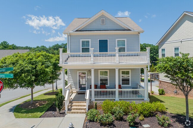 A beautifully maintained two-story homes with elegant columns and a blooming front yard illustrates the neighborhood's balance of traditional Southern architecture and curb appeal. The