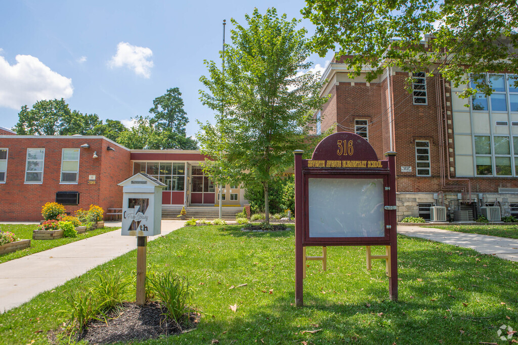 Seventh Avenue Elementary School in Haddon Heights, New Jersey has a free library in front.