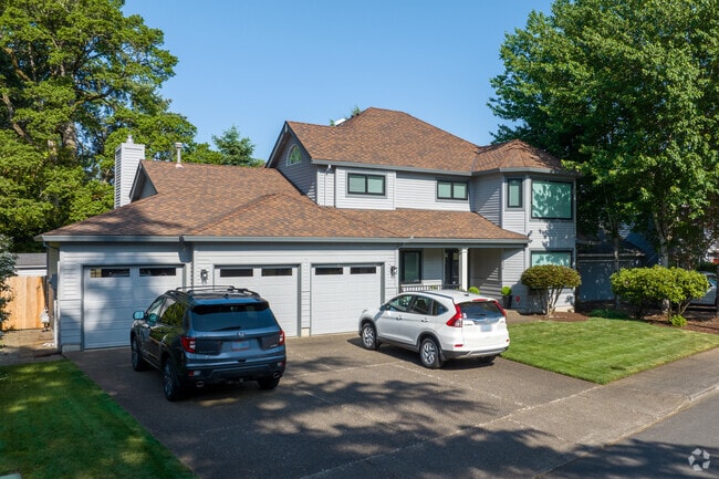 A large contemporary home with a bridge red roof along SW Partridge Drive in Lake Forest.