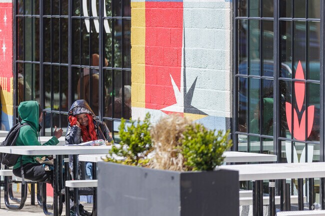 Cross Street Market offers outdoor seating near Riverside.