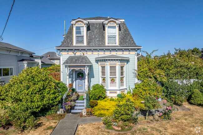 This 1800’s Victorian home has a bay window and dormers in City Center.