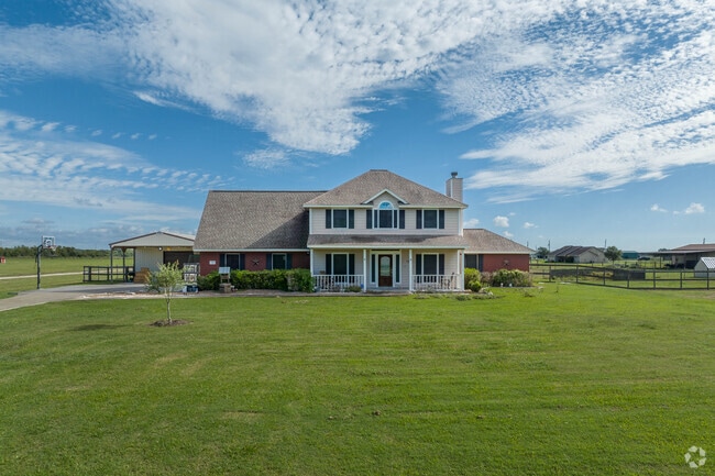 A two-story home sits on a large lot on the outskirts of Danbury, Texas.