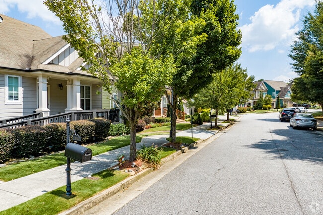 Houses in Hills Park feature short lawns shaded by mature trees.