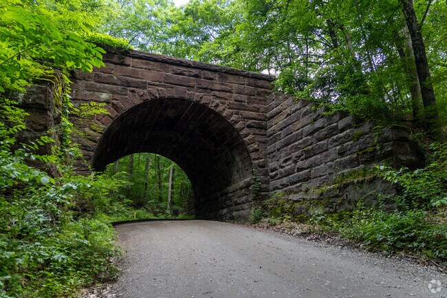 Salmon River State Forest features a historic stone archway and wooded trails.
