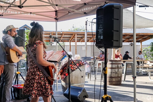 Patrons enjoy the live music from Honey Trail at Barbarian Brewing in Garden City.