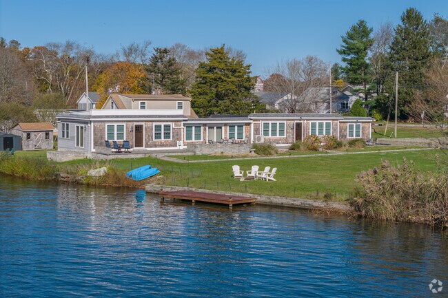 An elegant pond-side home in  the Bliss Corner neighborhood has ample yard space for fun.