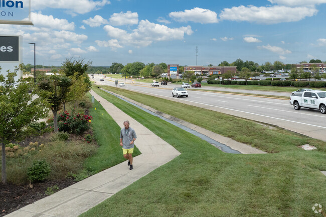 Park DeVille residents use the sidewalk along West Broadway Street for jogging.