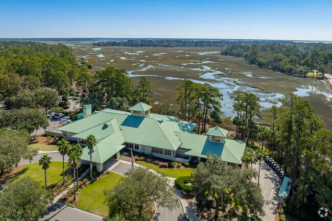 The Moss Creek clubhouse is surrounded by lush and beautiful green marsh and woodlands.