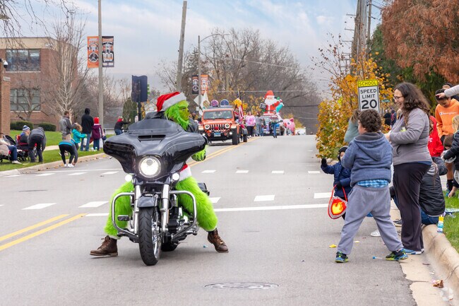 Motorcycles rev up the fun as riders toss candy to kids from Sunrise Ridge.
