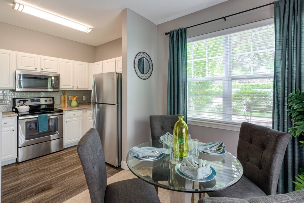 White cabinets with stainless steel microwave, stove and refrigerator.