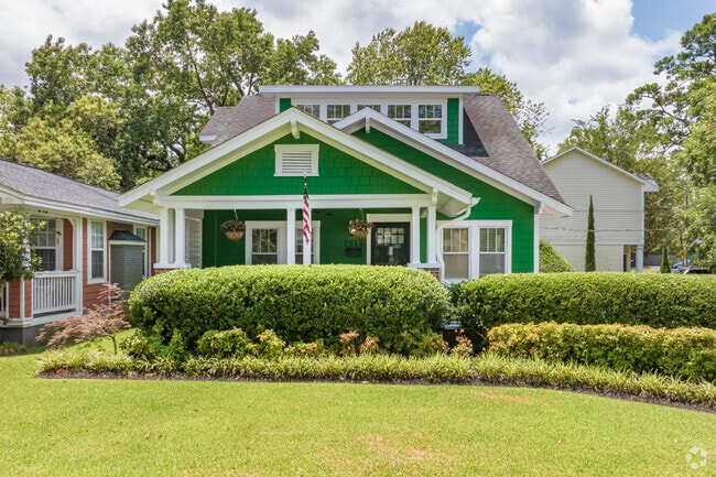 A cottage in Carolina Place is showcased by a well-manicured lawn.