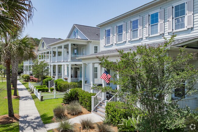 Find beautiful rows of modern coastal style homes with palm trees and sidewalks in Rivertowne.