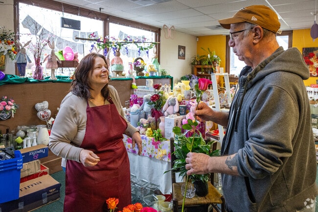 A customer inspects a rose when purchasing a bouquet at Phillipsburg Floral Co.