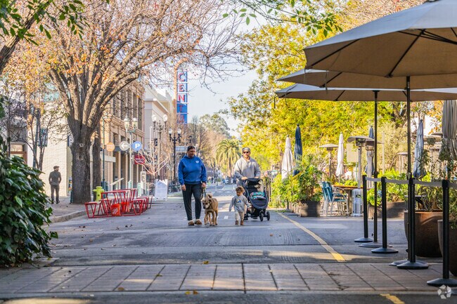 A family enjoys a leisurely stroll through downtown Redwood City.