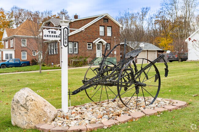 A resident in Lawndale reuses an old piece of farm equipment as a landscape decoration.