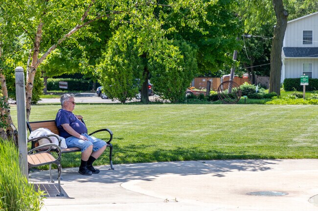 Residents enjoy the sun and warmer weather on the benches in Near West Galena.