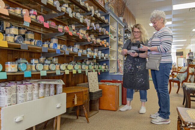 A Portage resident gets help picking out the perfect paint at Beautifully Blemished Market.