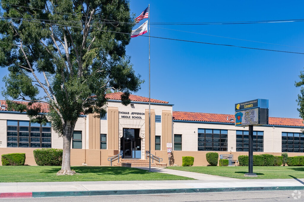 An American flag waves outside the entrance to Thomas Jefferson Middle School in Wasco.