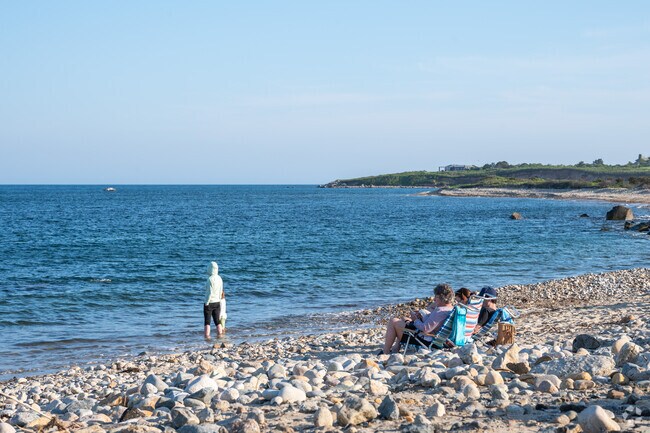 A family listens to waves lap the shores of Squibnocket Beach in Chilmark.