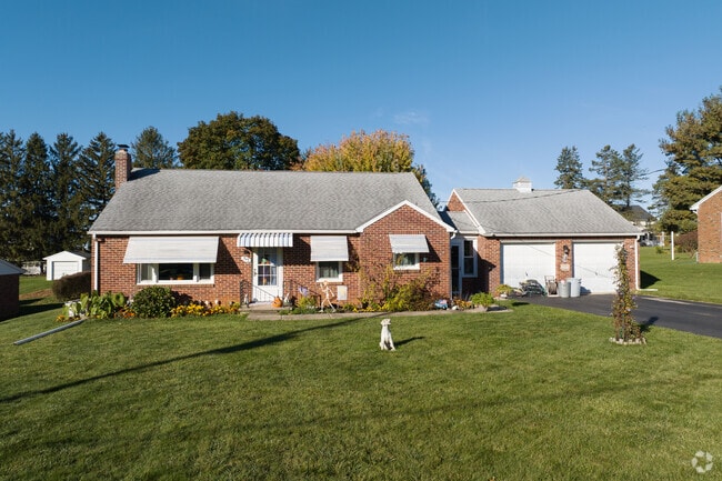 A perfect example of a brick ranch home with detached garage.