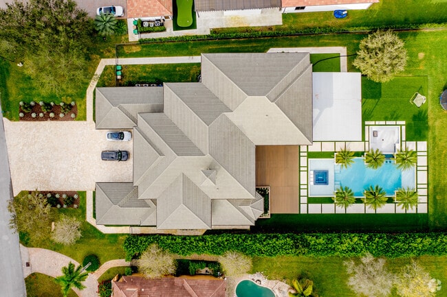 Bird's eye view of a large home in Flamingo Groves with a pool.