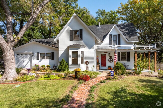 Beautiful cottage-style homes with brick walkways are found near downtown Manhattan.