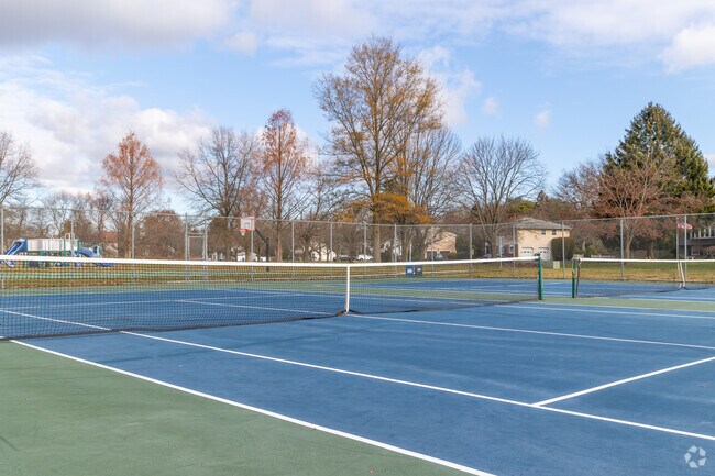 Gather with friends at the tennis courts in Sandy Brook Park.