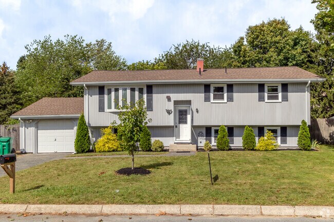 This raised ranch style home is augmented by a bay window in the Oakland Beach neighborhood.