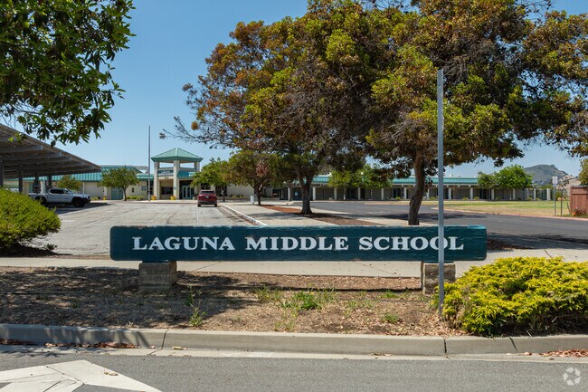 A wooden sign outside the entrance to Laguna Middle School welcomes Prefumo students.