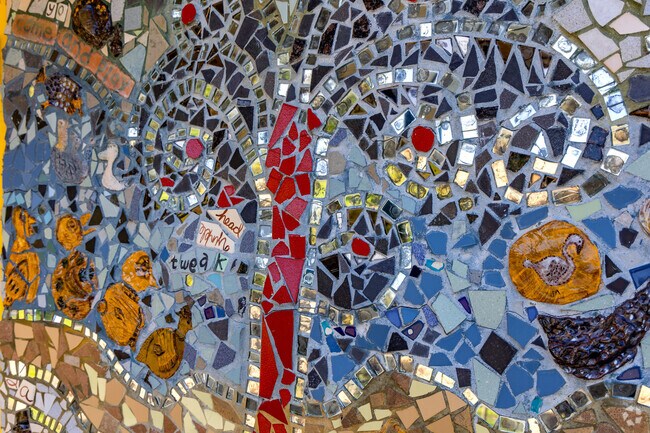 A colorful mirrored mosaic decorates the community building at Wilson Park.