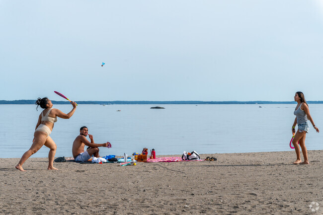 Residents enjoy the sandy beach at Cove Island Park.