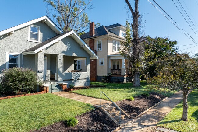 West End homes line gridded streets with fenced, manicured green yards.