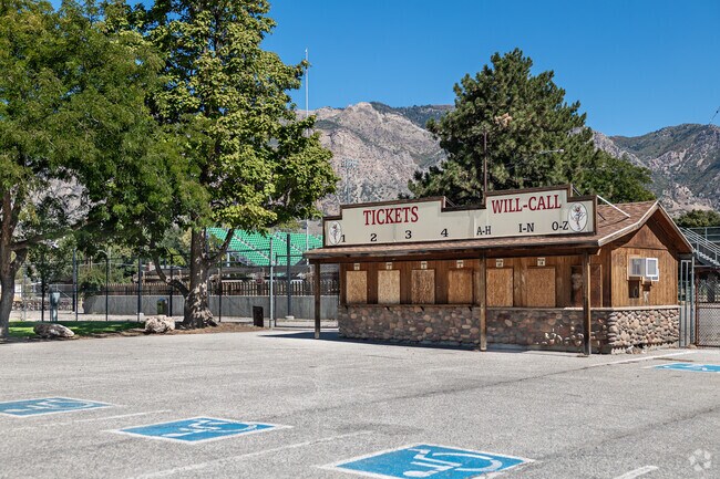The ticket station to Ogden Pioneer Days Rodeo is surrounded by trees and mountains.
