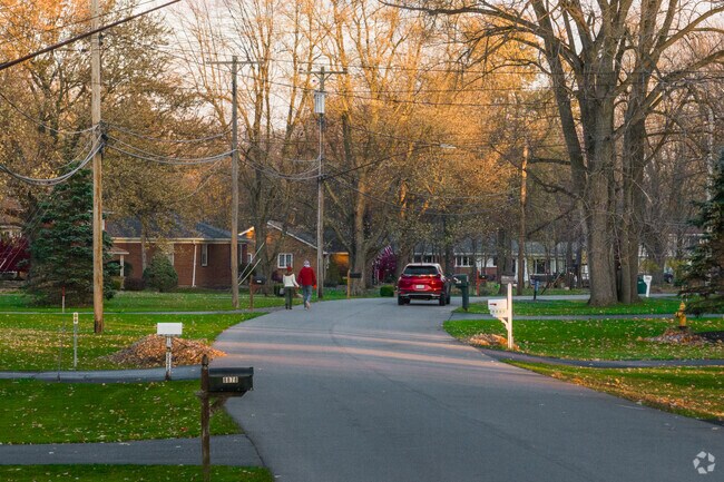 A couple walks along the quiet streets of Harris Hill.
