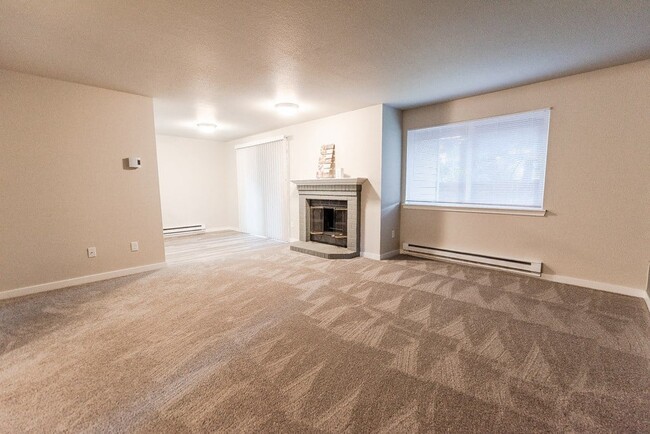 Puyallup Apartments - Cambridge on Seventh Apartments - Living Room, Fireplace, and Dining Room