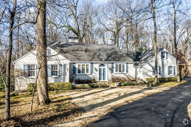 Larger ranch-style home with a long driveway in Colonial Acres.