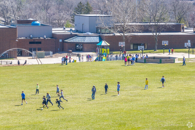 Students enjoy updated playground equipment and wide open fields during recess.