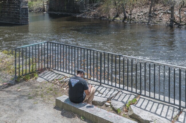 Enjoying the natural beauty of Valley Falls is found while reading by the Blackstone River.