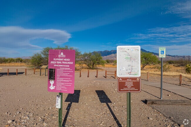 Informational signs mark the entrance to a local trailhead in the Elephant Head area, offering access to scenic desert landscape.