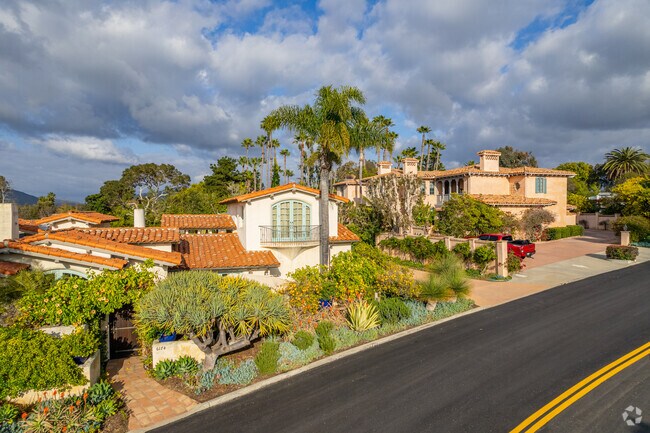 Rancho Santa Fe homes feature large palm trees in their front yards.