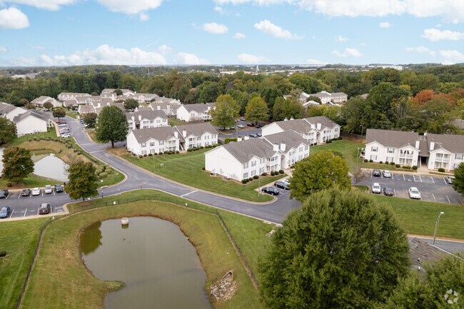 An aerial view of white apartments and condos near the Wendover Place shopping plaza.
