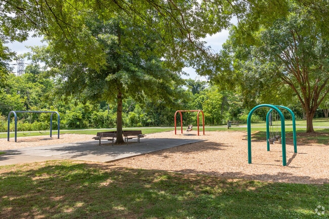 Parents relax in the shade while the kids play at Seversville Park.