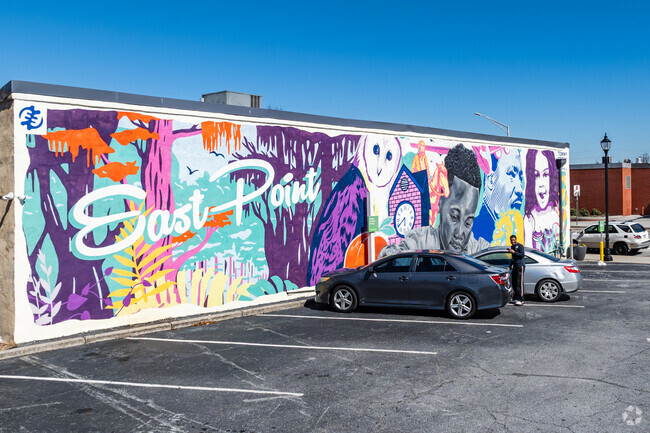 Colonial Hills residents admire the Downtown East Point mural, which showcases the city’s diversity and resilience.