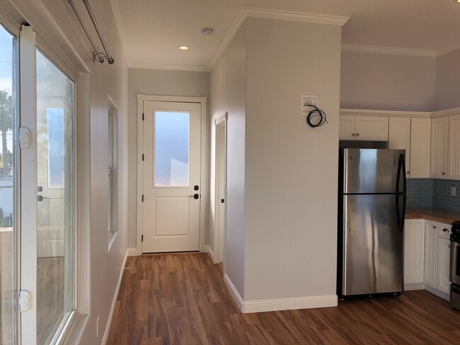 Front door 8-feet tall, front hallway with bathroom and laundry door.