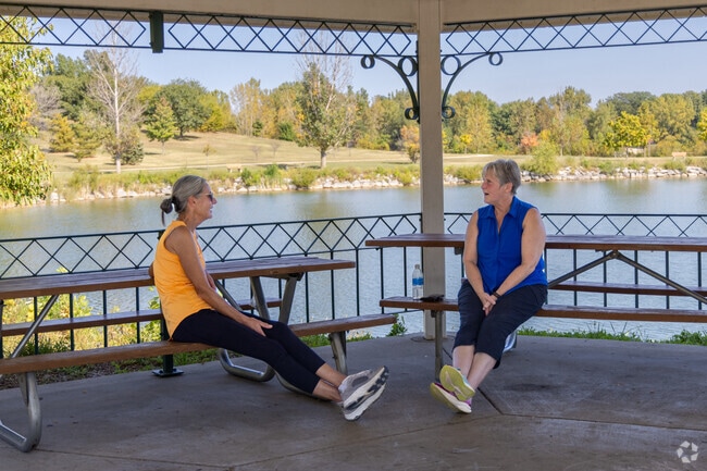 Friends relax and chat under a pavilion next to Baumann Lake in Cherry Valley.