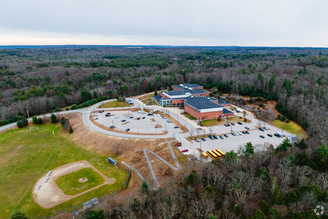 Douglas High School is bordered by groves of densely packed trees.